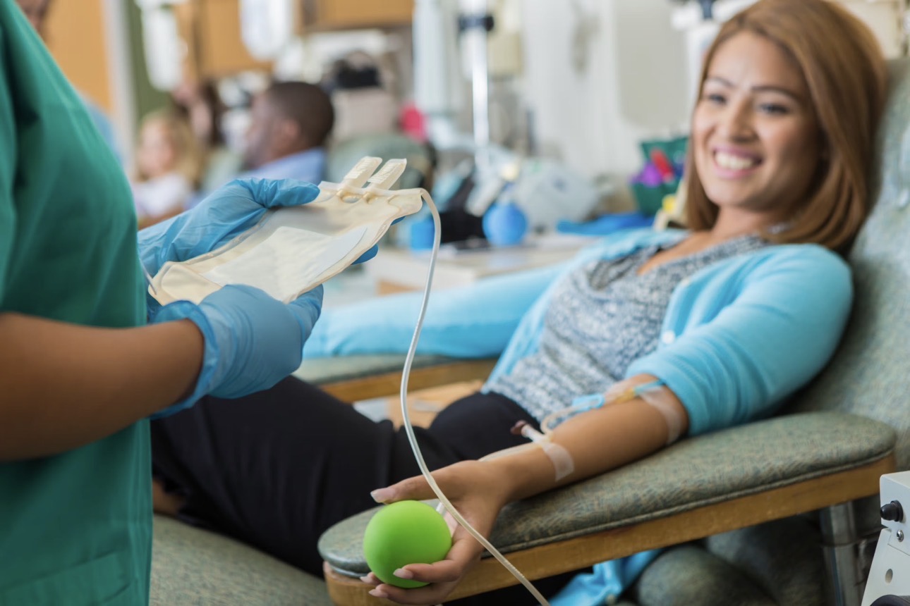 Phlebotomist performing a professional blood draw on a patient